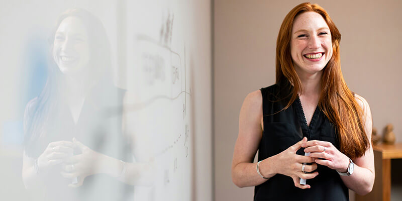 A woman at a whiteboard